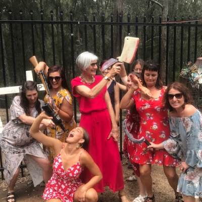 a group of people standing next to a fence