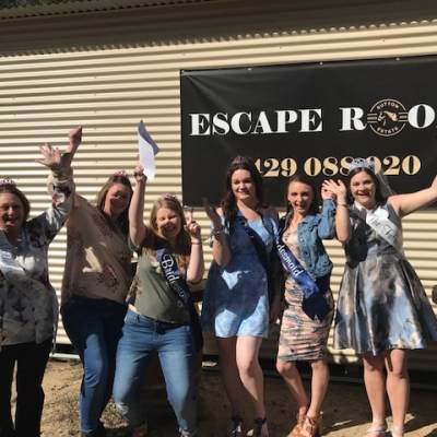 a group of people standing in front of a crowd posing for the camera