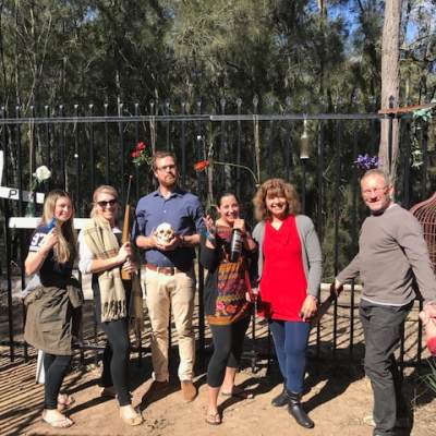 a group of people standing in front of a fence