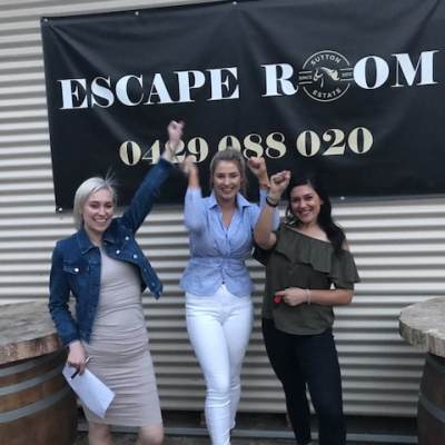 a person standing in front of a group of people posing for the camera