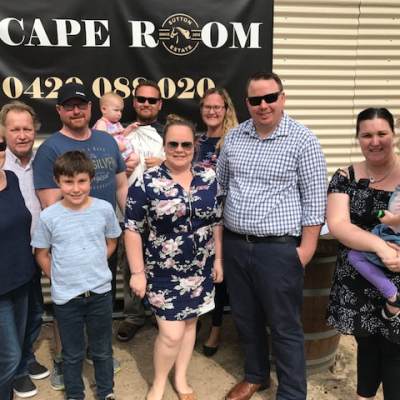 a group of people standing in front of a crowd posing for the camera