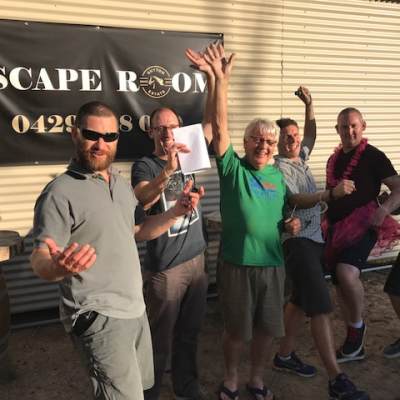 a group of people standing in front of a crowd posing for the camera