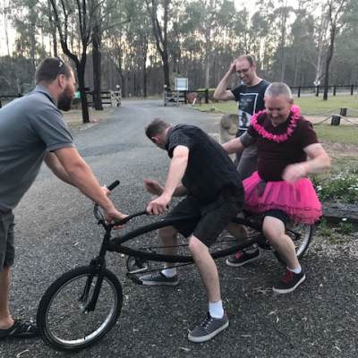 a group of people riding on the back of a bicycle