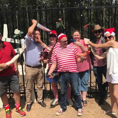 a group of people standing in front of a crowd posing for the camera