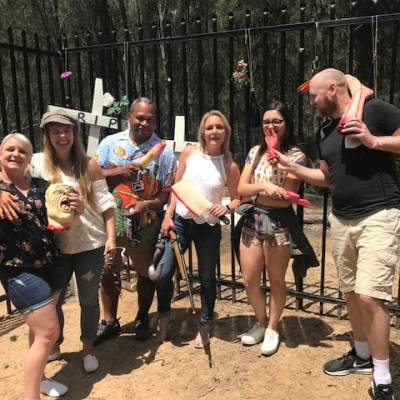 a group of people standing in front of a crowd posing for the camera