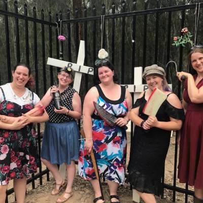 a group of people standing in front of a crowd posing for the camera