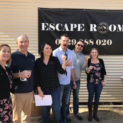 a person standing in front of a group of people posing for the camera