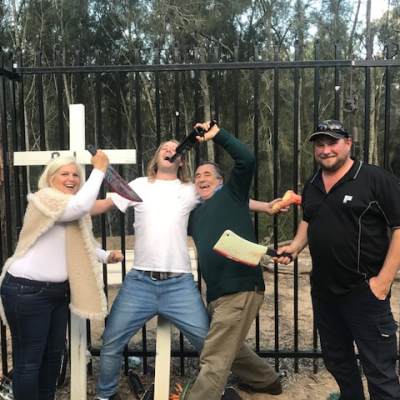 a group of people standing next to a fence