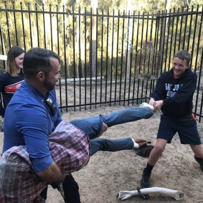 a man standing next to a fence