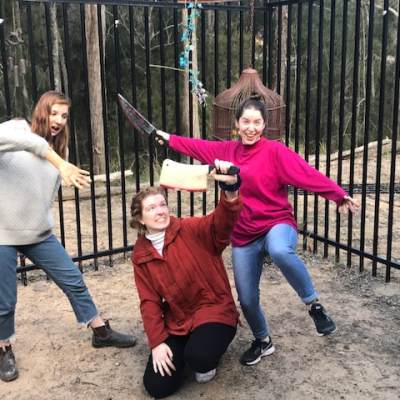 a group of people playing frisbee in a fenced in area