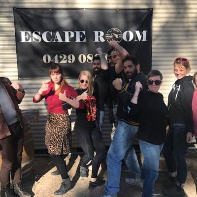 a group of people standing in front of a crowd posing for the camera