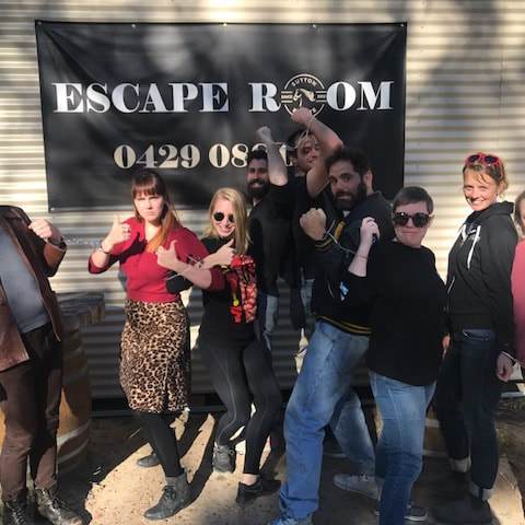 a group of people standing in front of a crowd posing for the camera