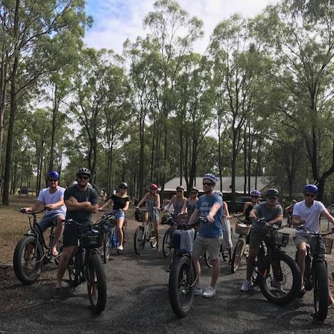 a group of people riding on the back of a bicycle