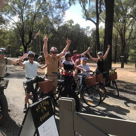 a group of people riding on the back of a bicycle