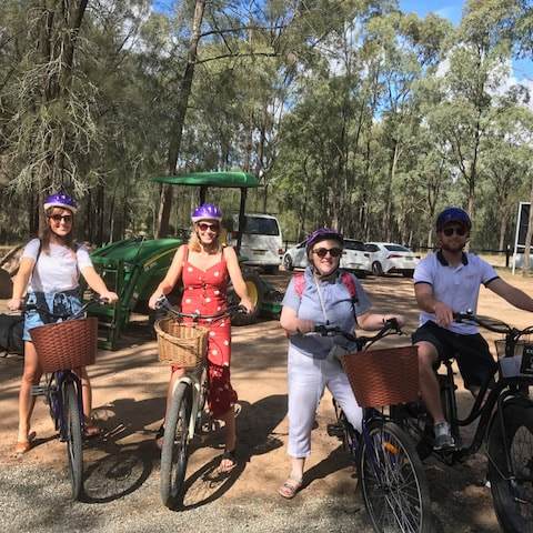a group of people riding on the back of a bicycle