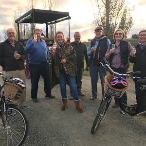 a group of people riding on the back of a bicycle