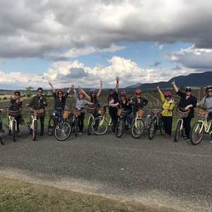 a group of people riding a motorcycle down a dirt road