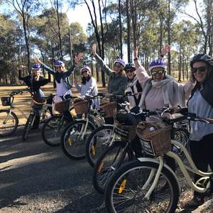 a group of people riding on the back of a bicycle