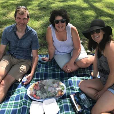a group of people sitting at a picnic table